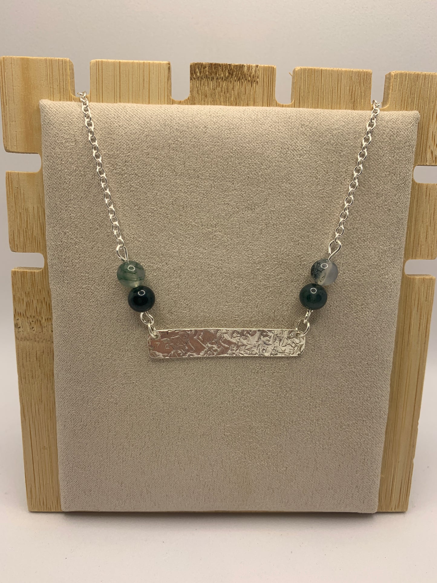 Handmade sterling silver hammered bar necklace with moss agate