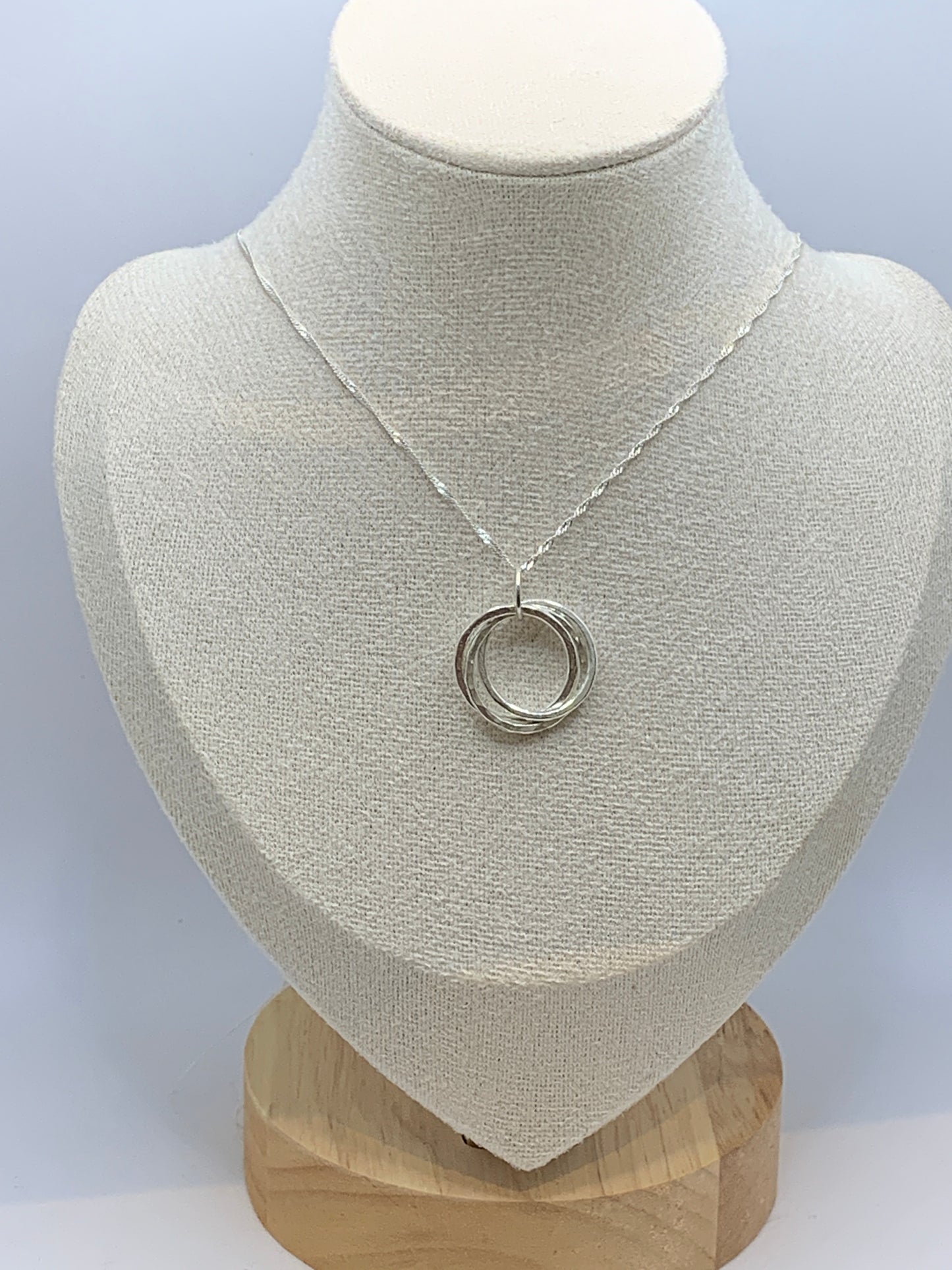 Handmade sterling silver hammered three ring pendant