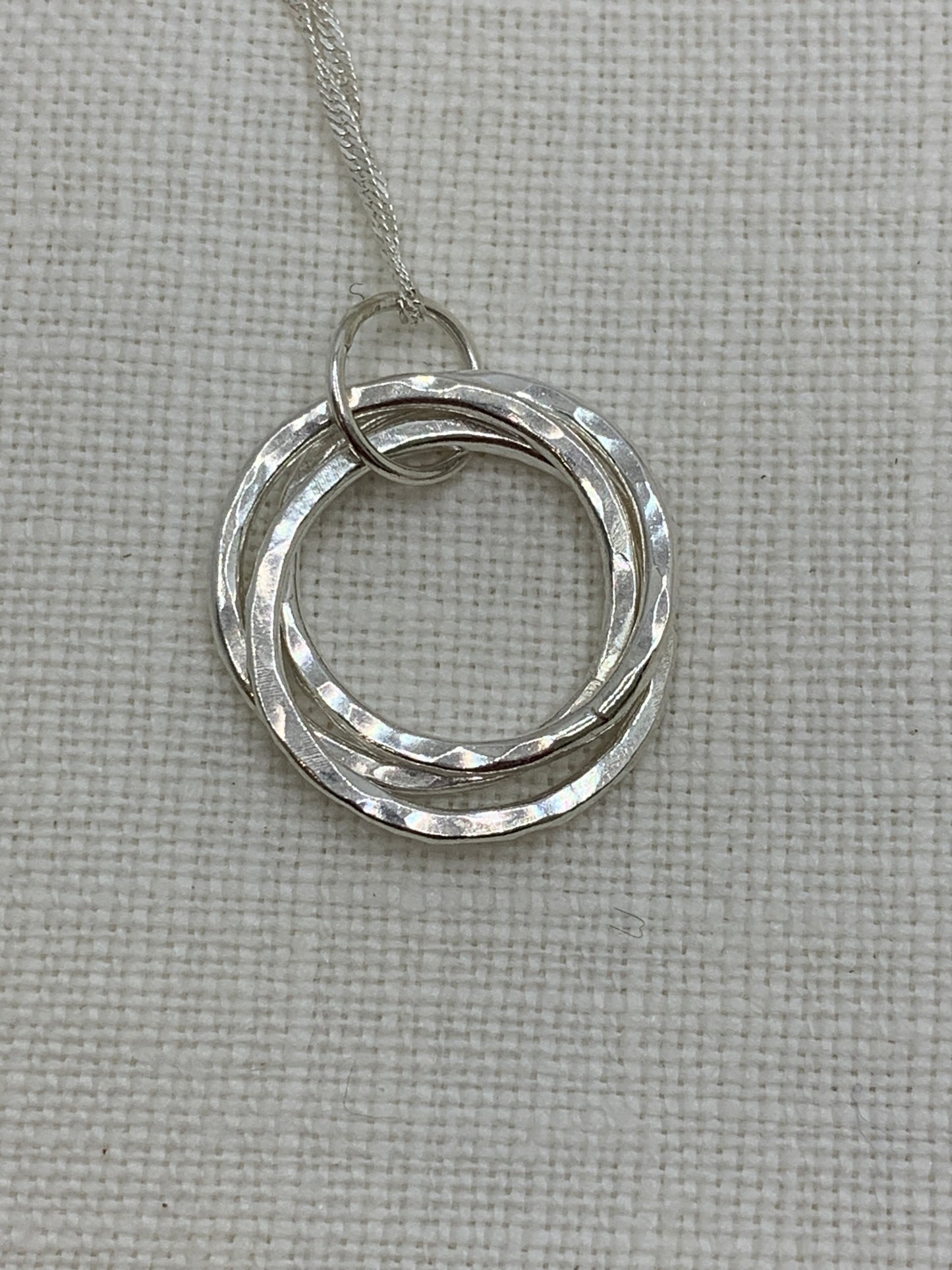 Handmade sterling silver hammered three ring pendant