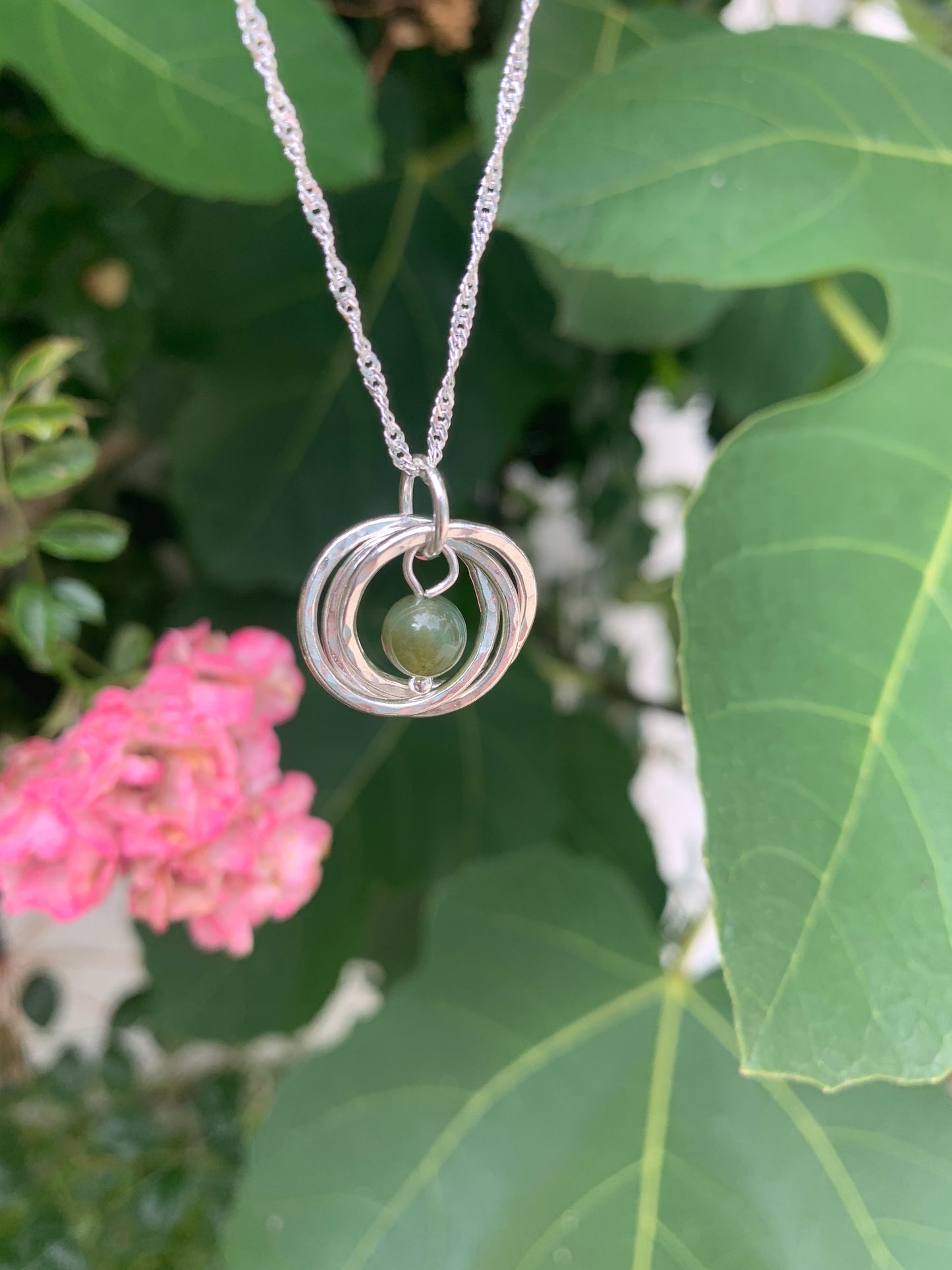 Handmade sterling silver three ring pendant with moss agate