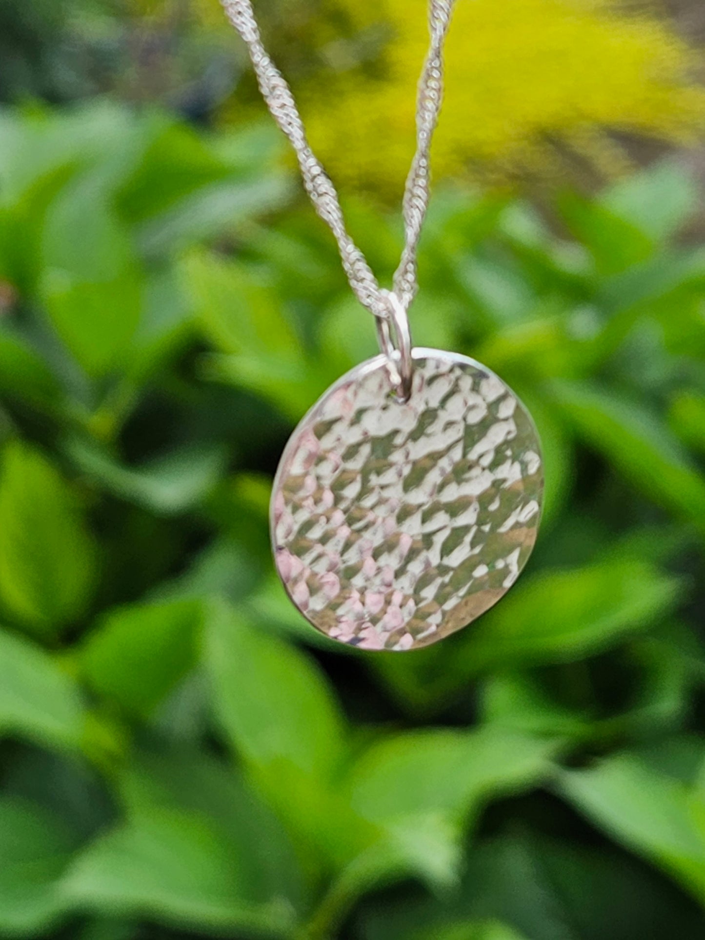 Handmade sterling silver hammered disc pendant