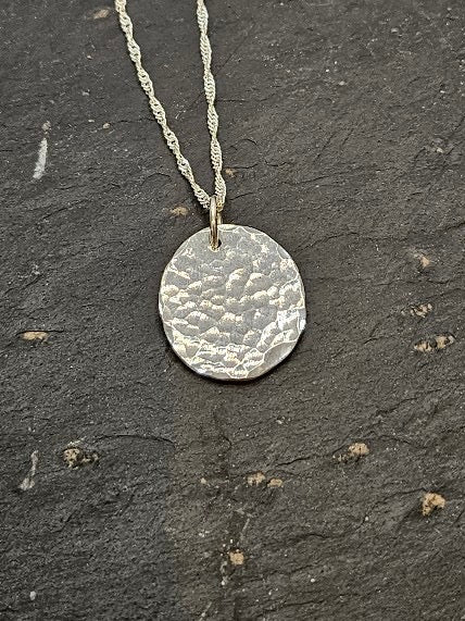 Handmade sterling silver hammered disc pendant