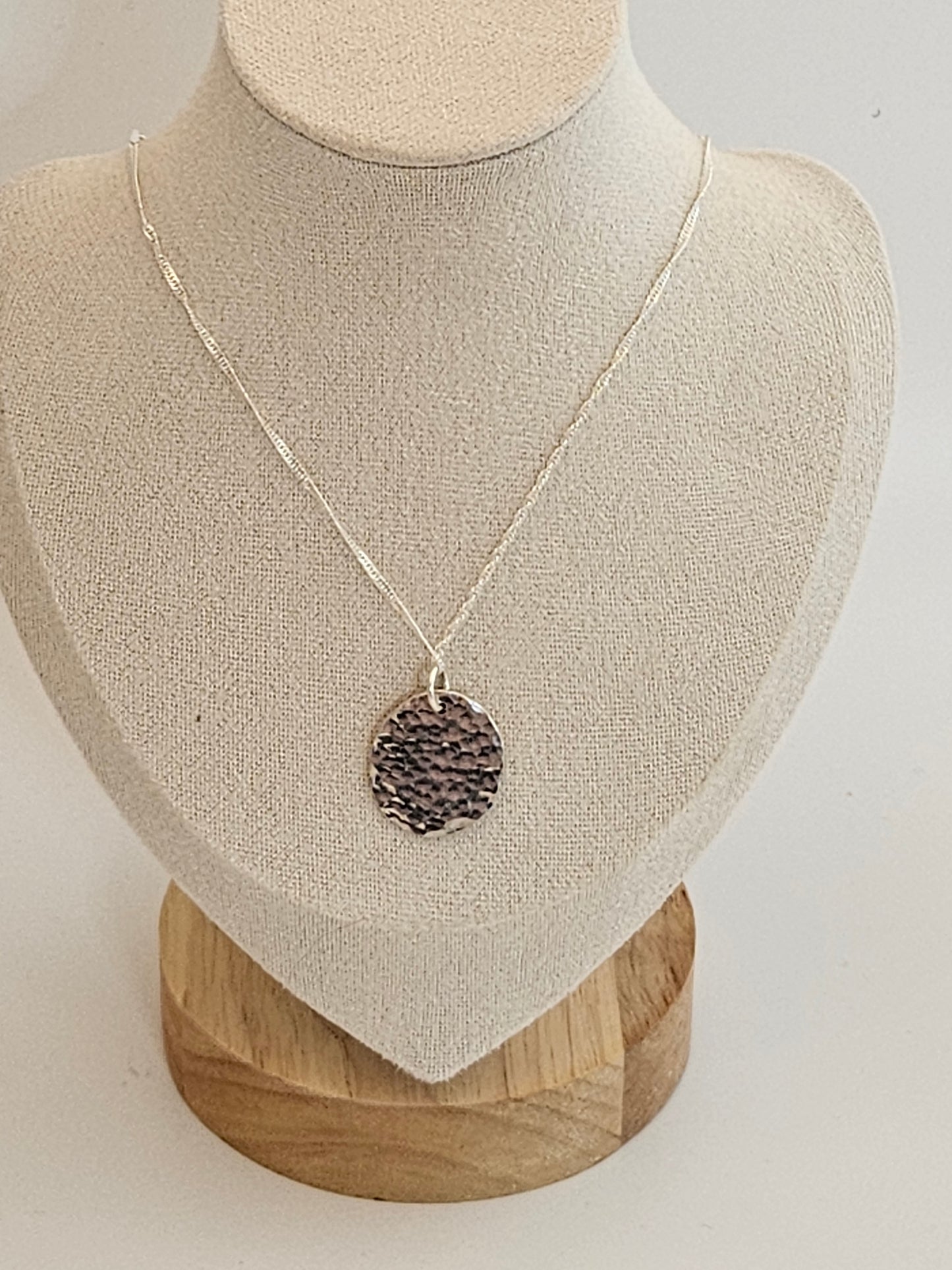 Handmade sterling silver hammered disc pendant