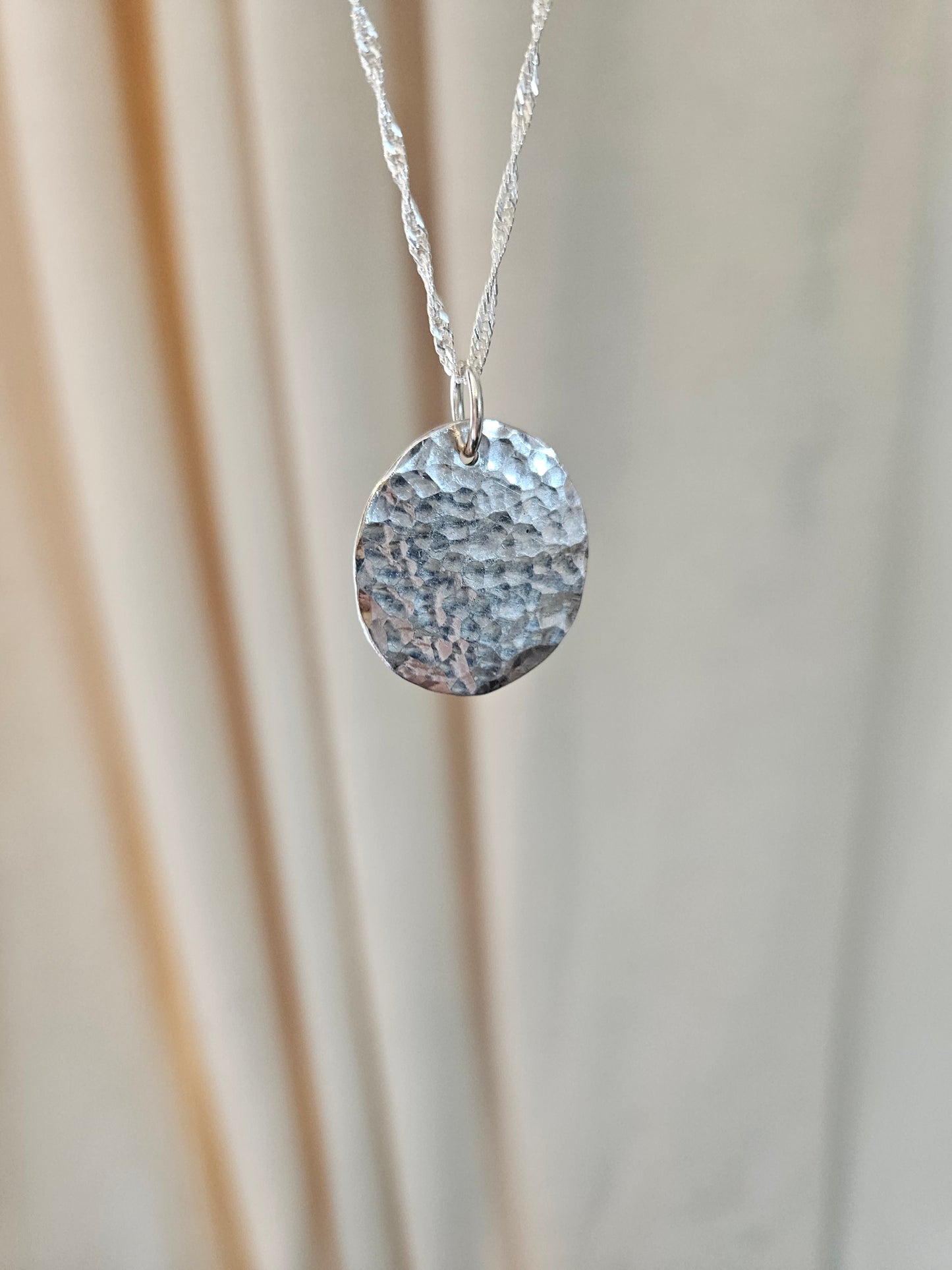 Handmade sterling silver hammered disc pendant