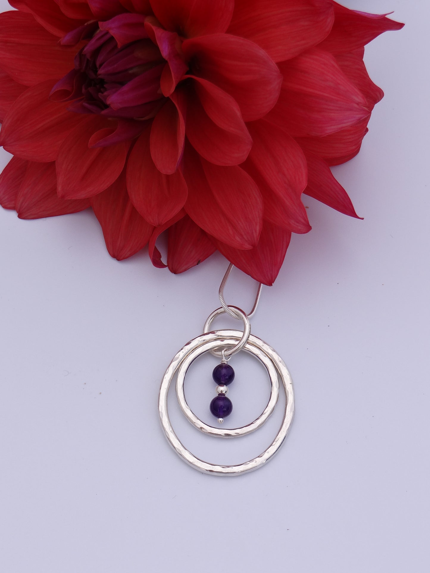 Handmade sterling silver hammered double ring pendant with amethyst