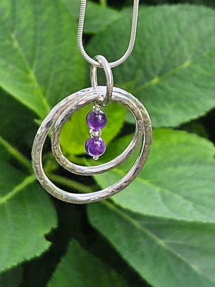 Handmade sterling silver hammered double ring pendant with amethyst