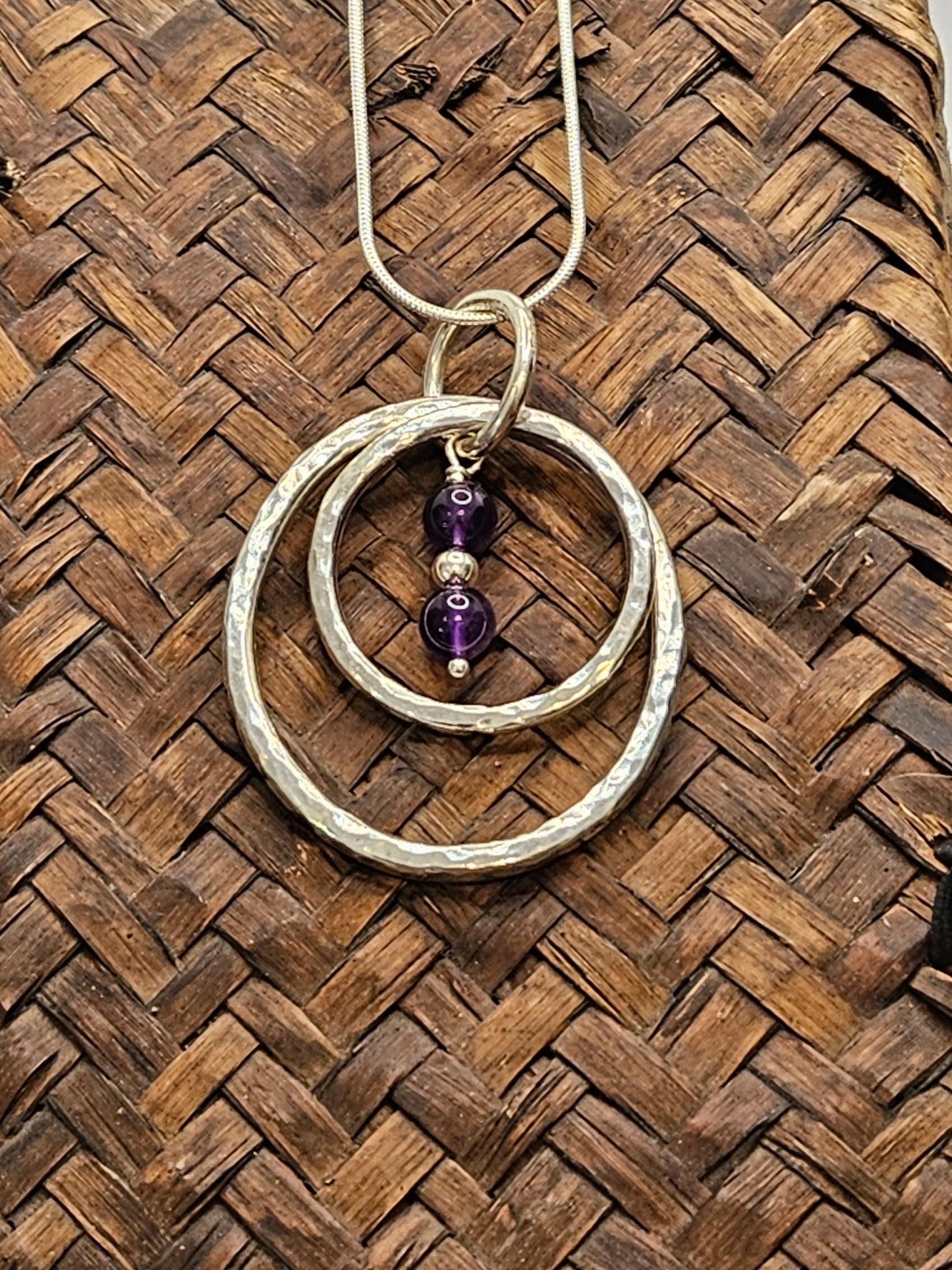 Handmade sterling silver hammered double ring pendant with amethyst