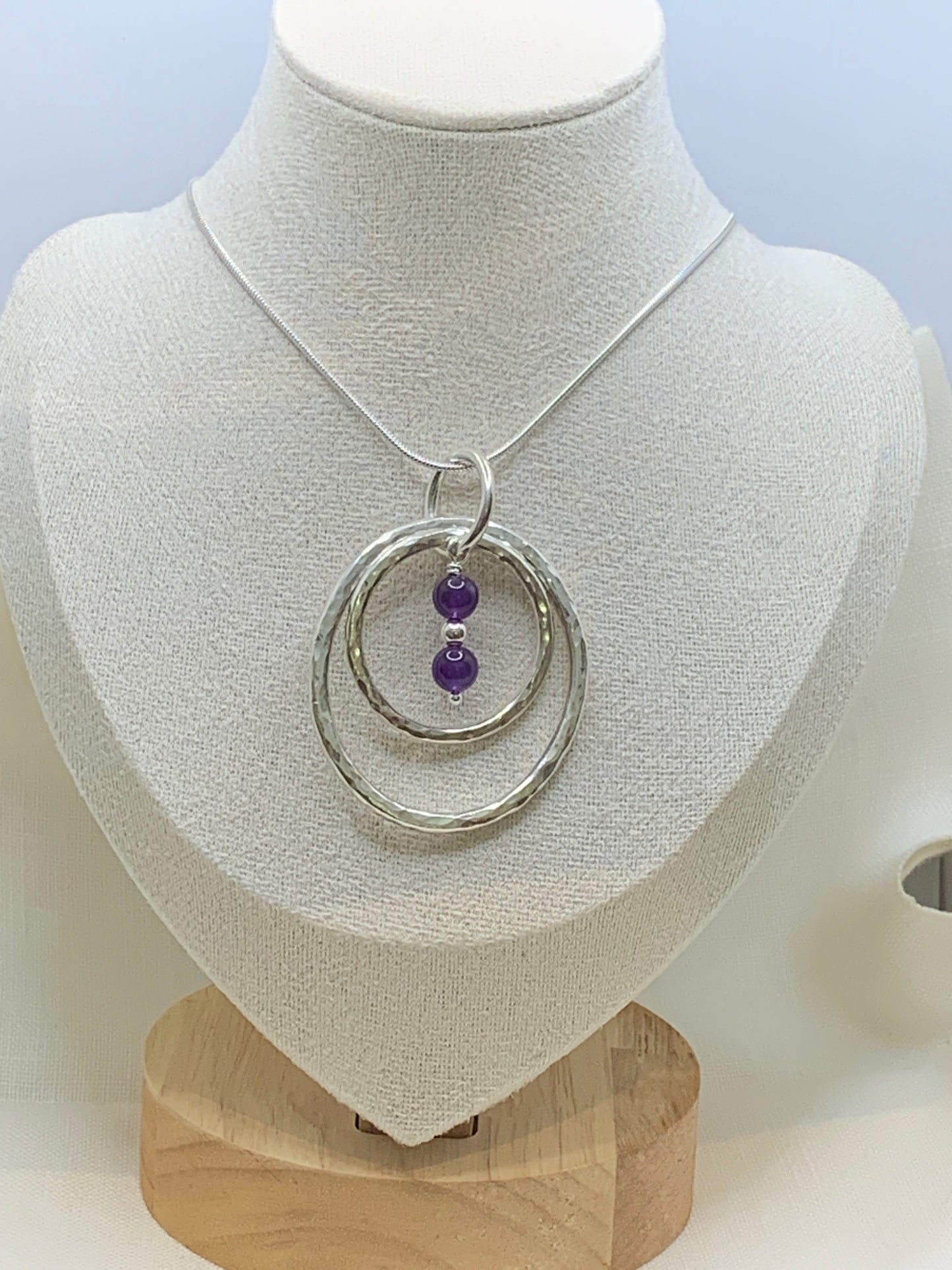 Handmade sterling silver hammered double ring pendant with amethyst