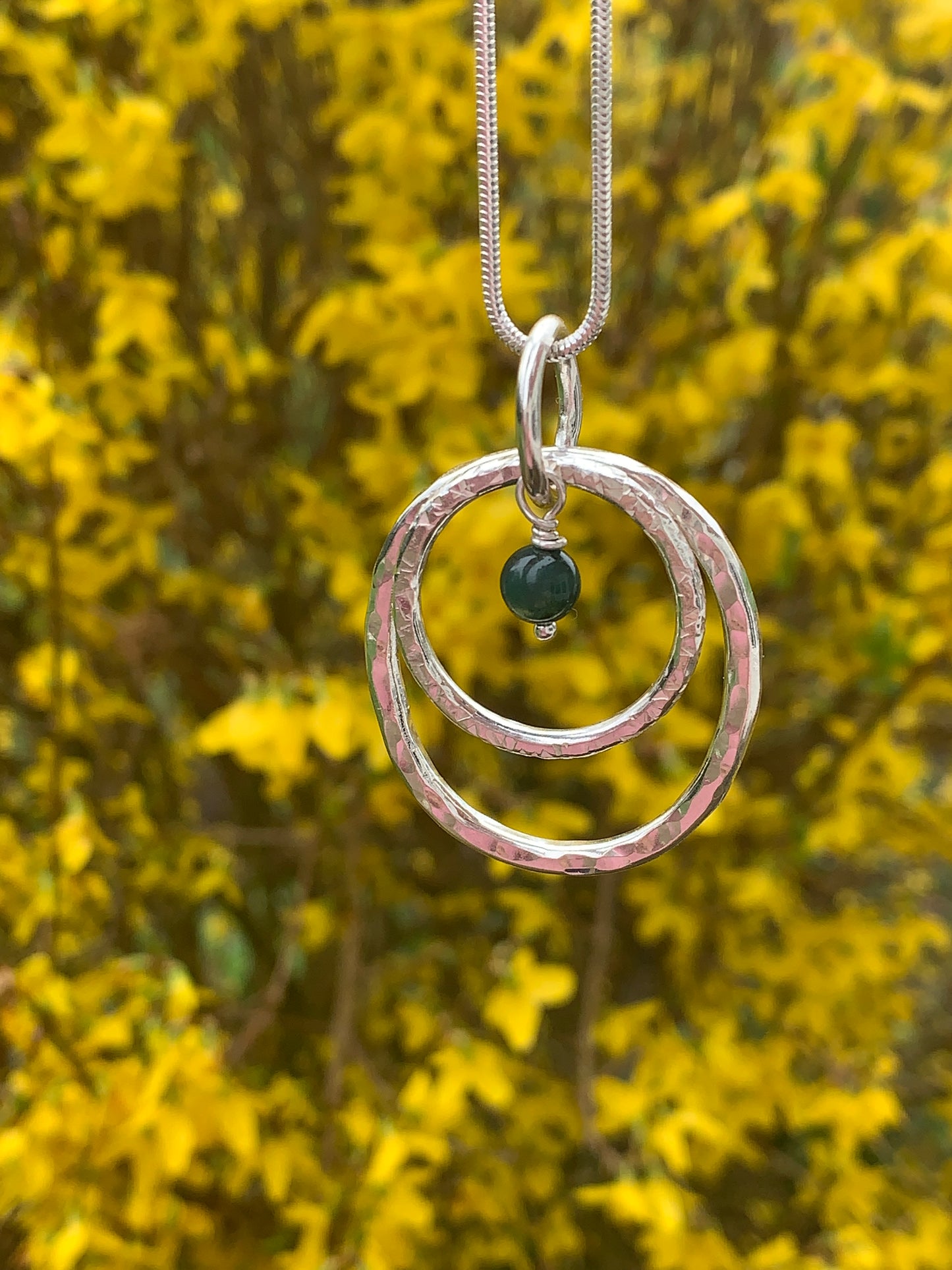 Handmade sterling silver hammered double ring pendant with moss agate