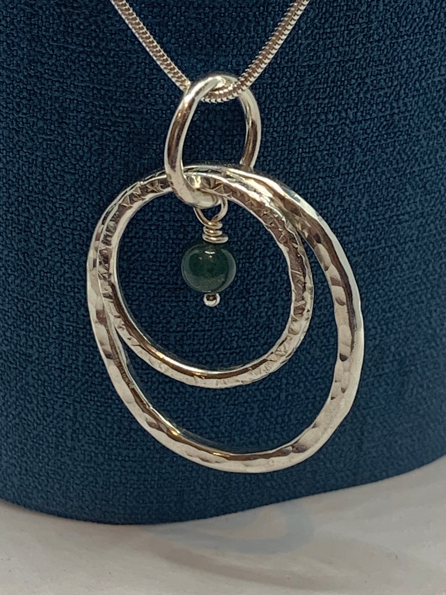 Handmade sterling silver hammered double ring pendant with moss agate