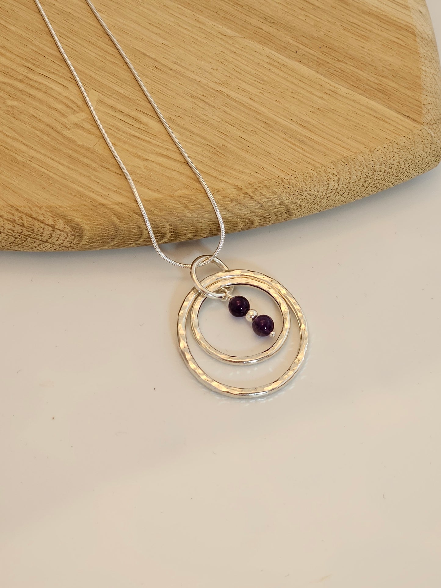 Handmade sterling silver hammered double ring pendant with amethyst