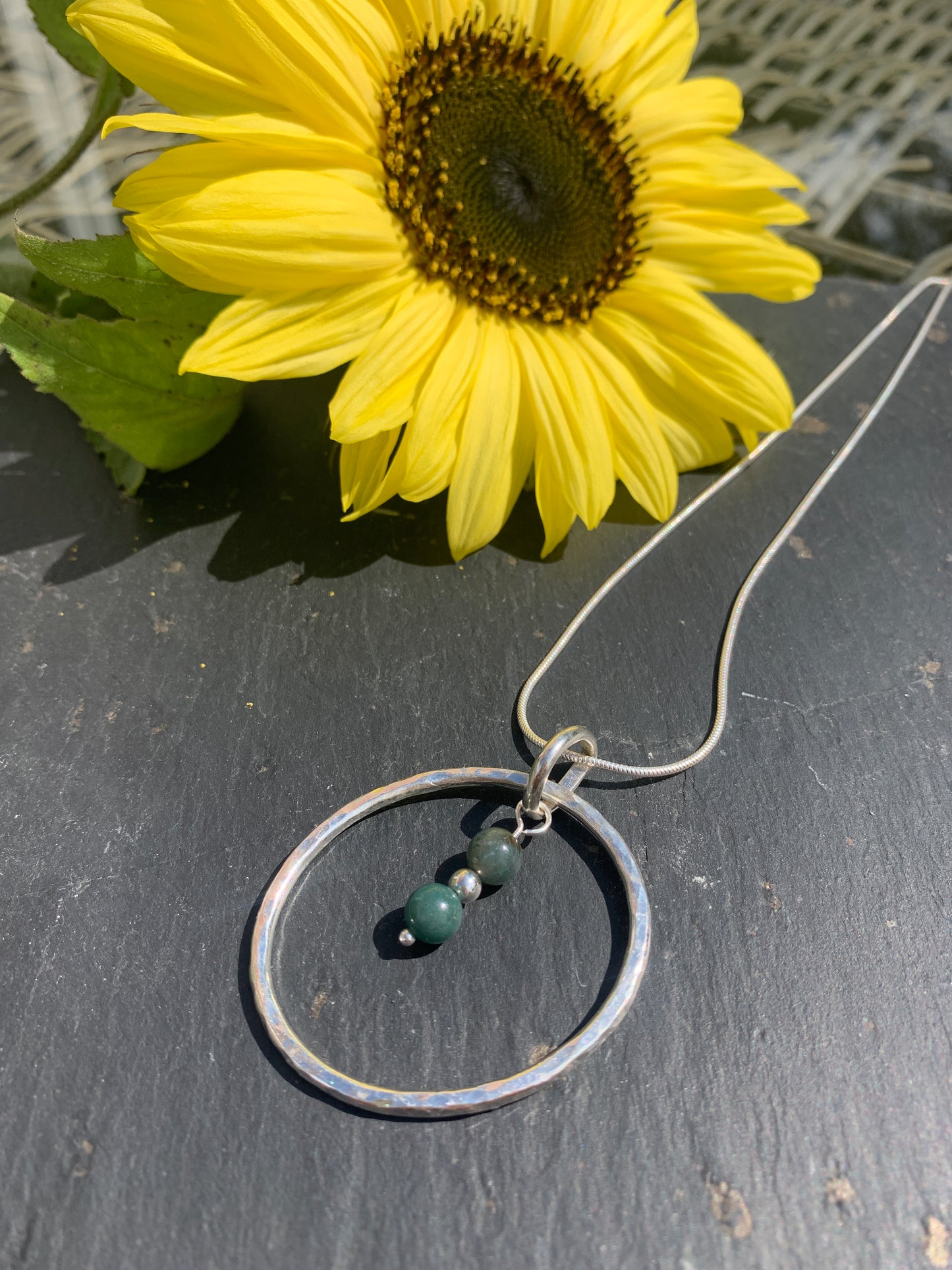 Handmade sterling silver hammered ring pendant with moss agate