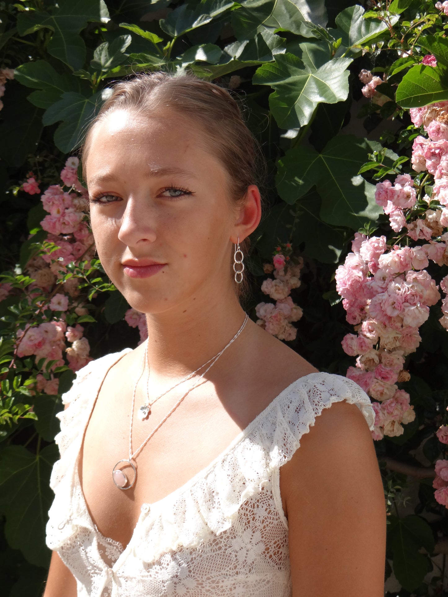 model wearing Handmade sterling silver hammered small circle drop earrings