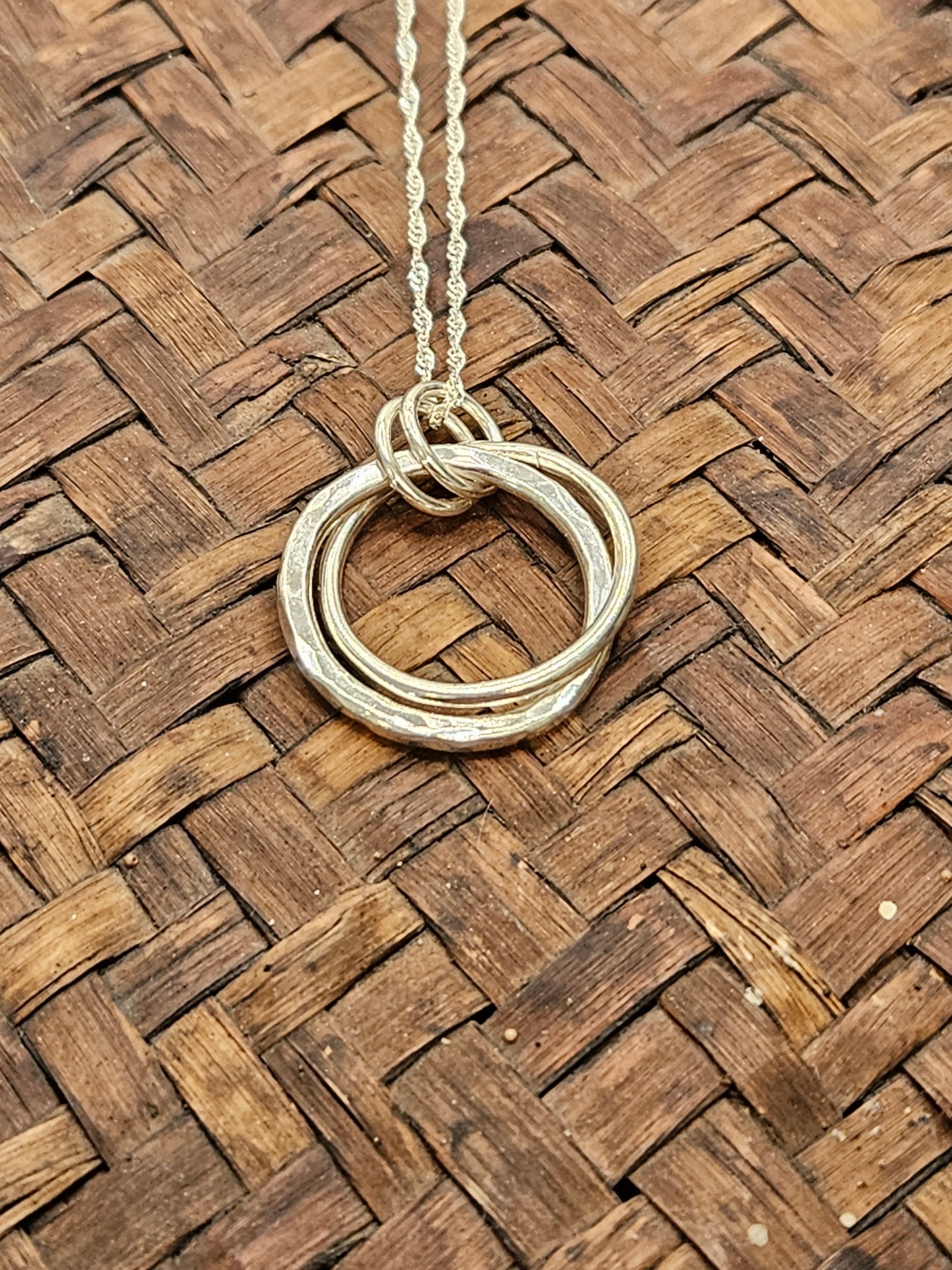 Handmade sterling silver hammered double ring pendant