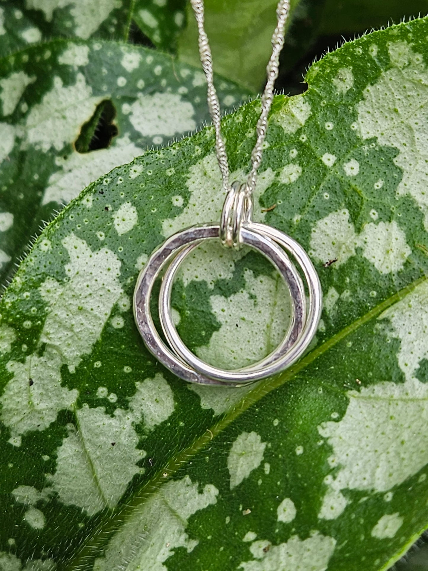 Handmade sterling silver hammered double ring pendant
