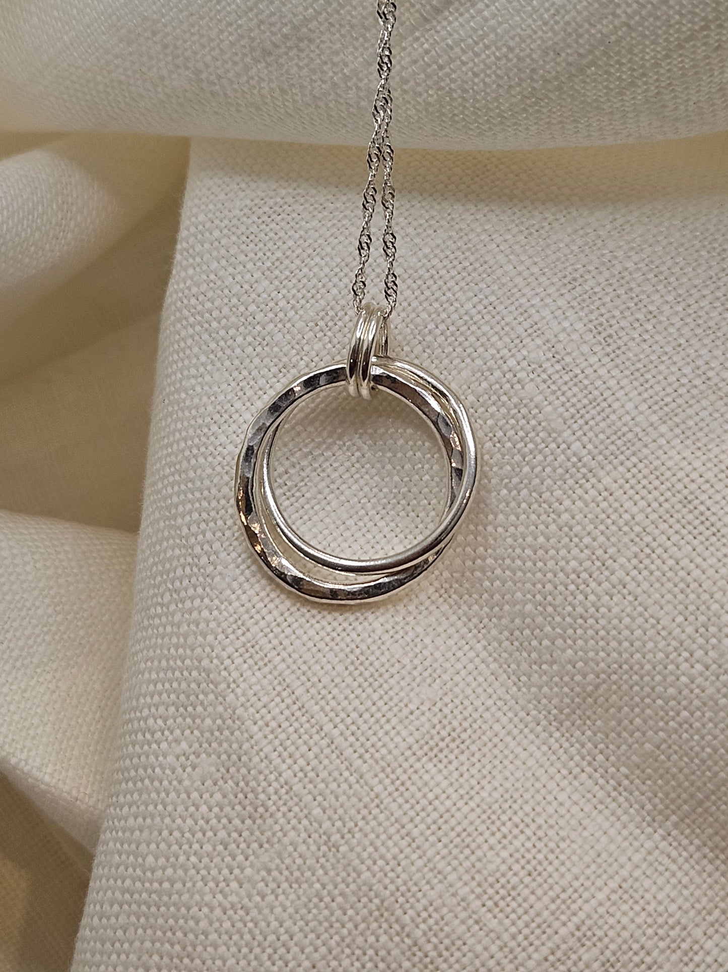Handmade sterling silver hammered double ring pendant