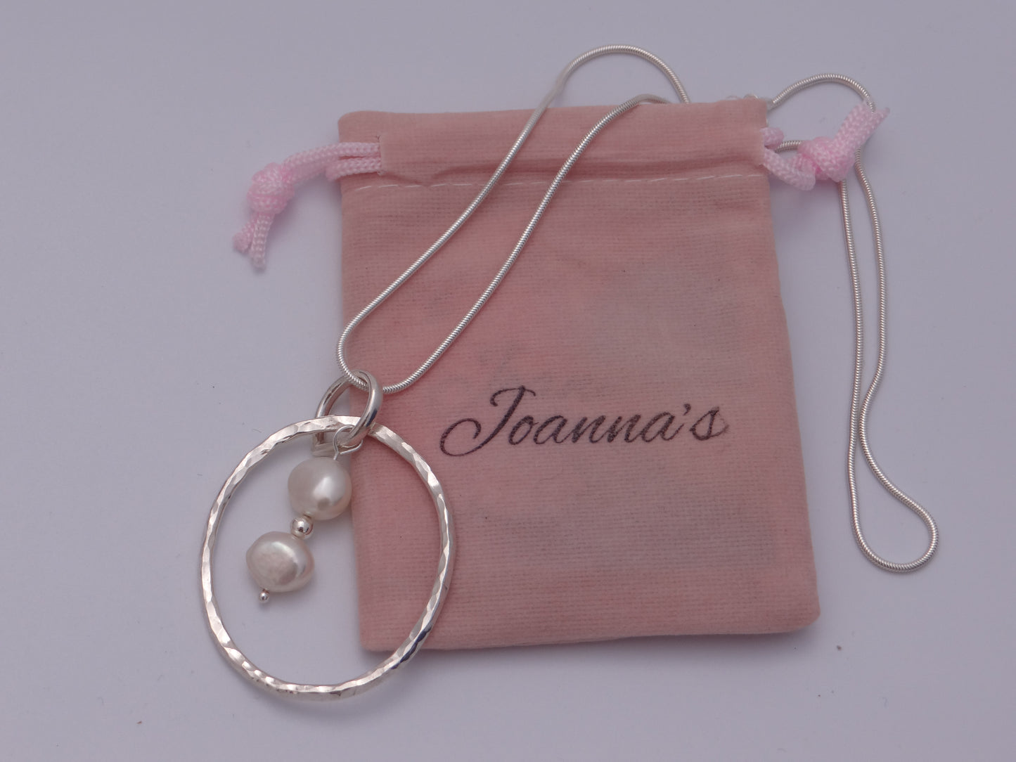 Joanna's Designs packaging with large circle sterling silver pendant with pearls