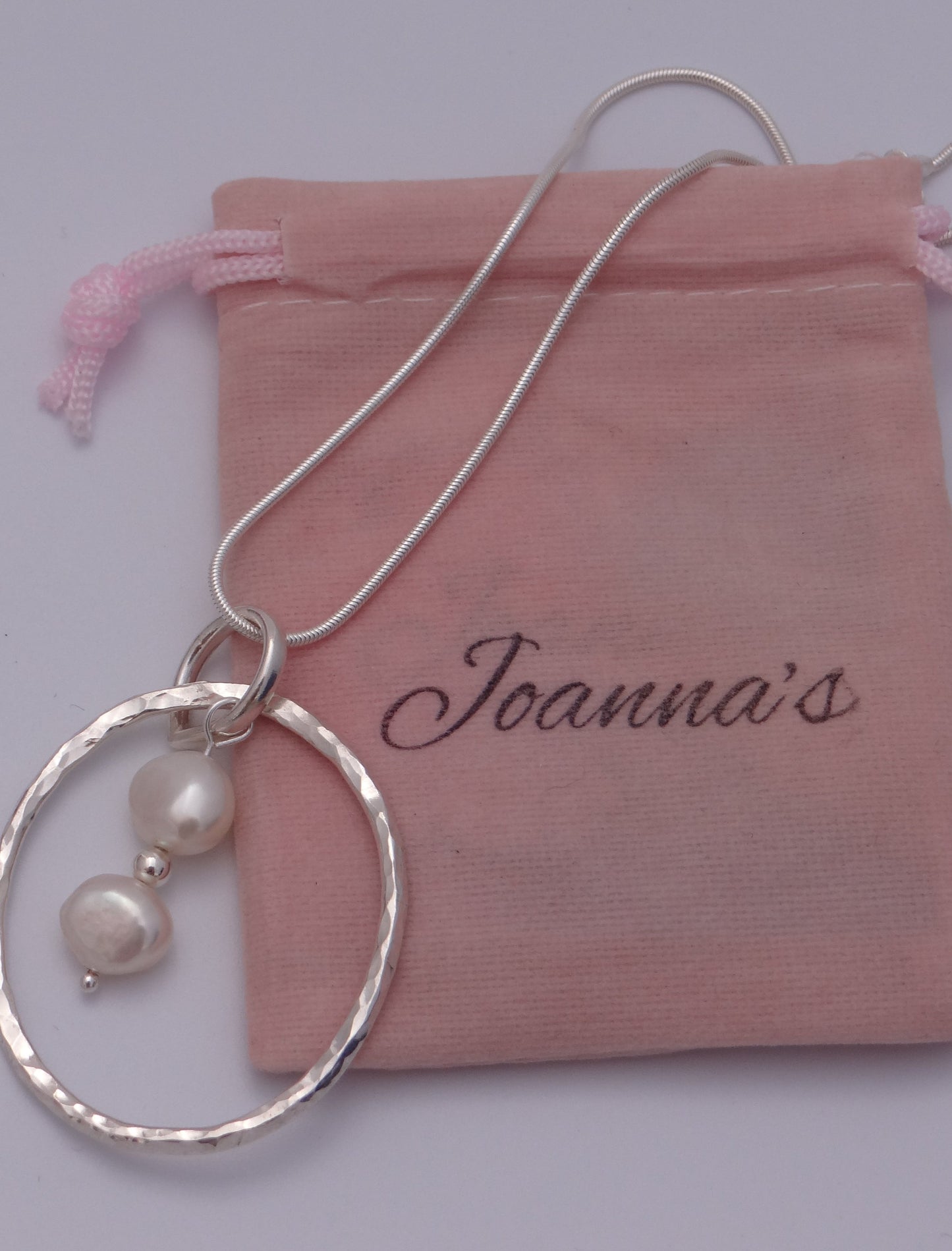 Joanna's Designs packaging with large circle sterling silver pendant with pearls