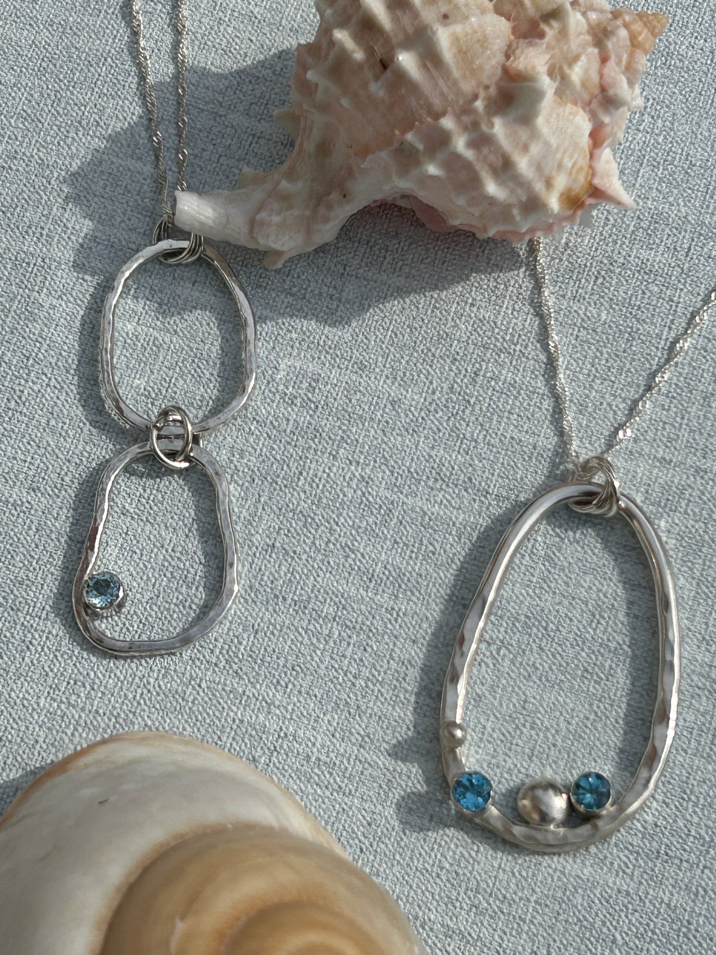 two pendants from the Provence collection. Handmade in sterling silver and blue topaz