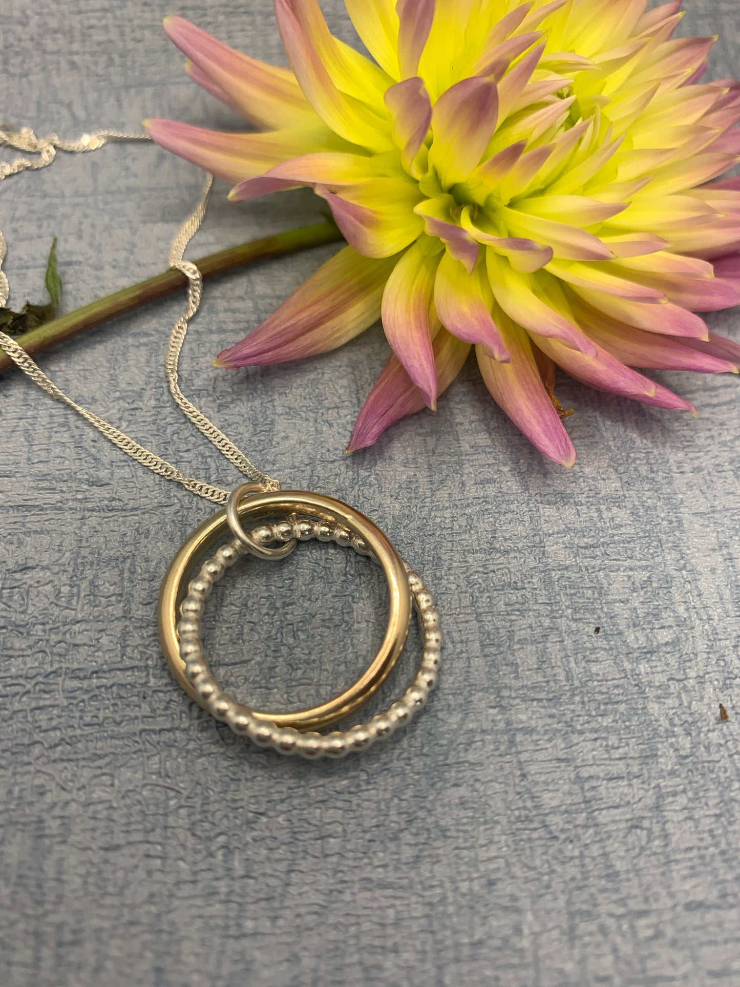 Handmade sterling silver and 9ct gold hallmarked entwined circle pendant