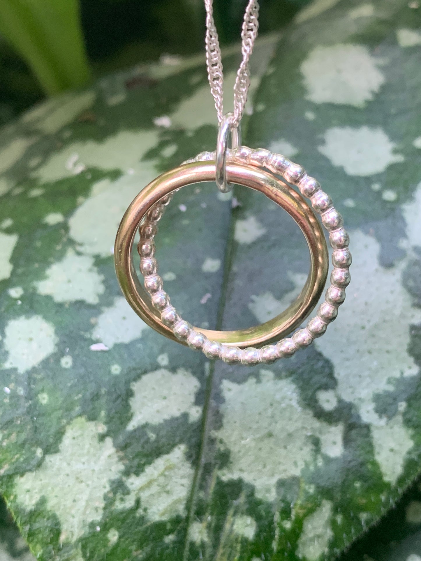 Handmade sterling silver and 9ct gold hallmarked entwined circle pendant