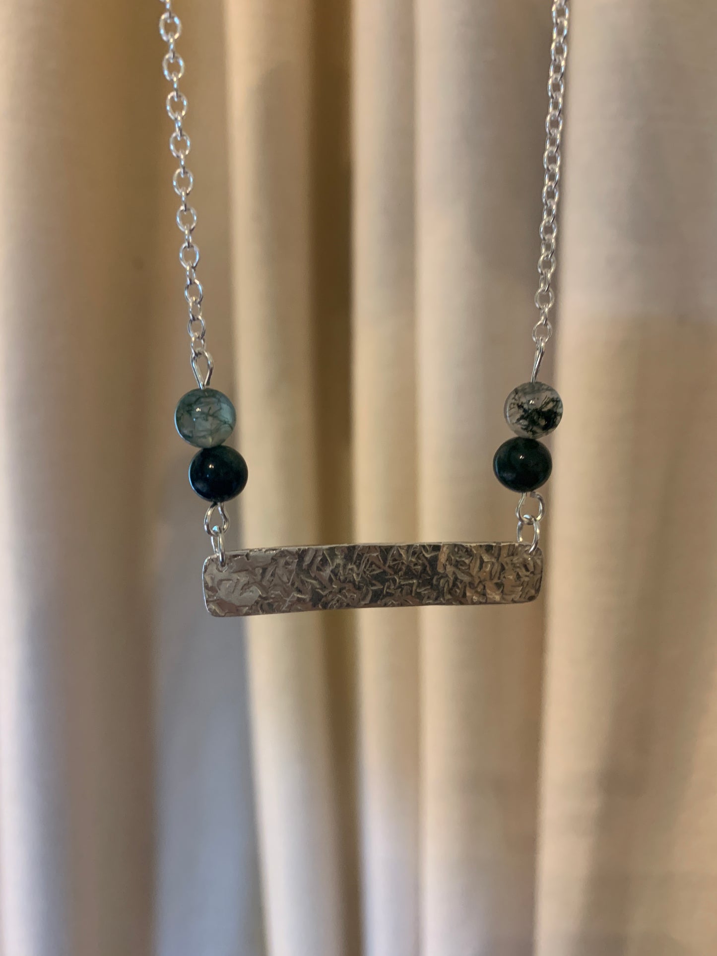 Handmade sterling silver hammered bar necklace with moss agate