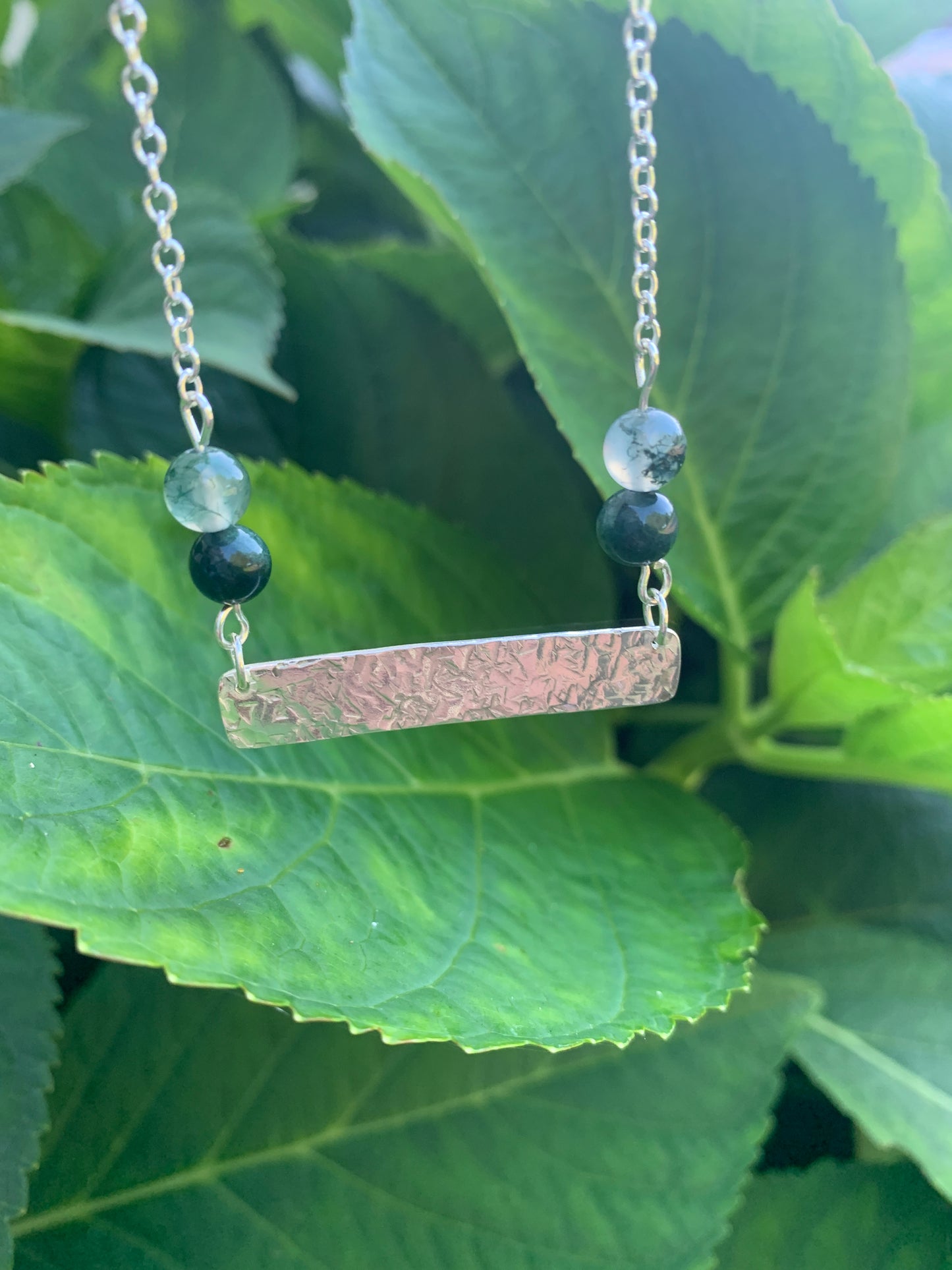 Handmade sterling silver hammered bar necklace with moss agate