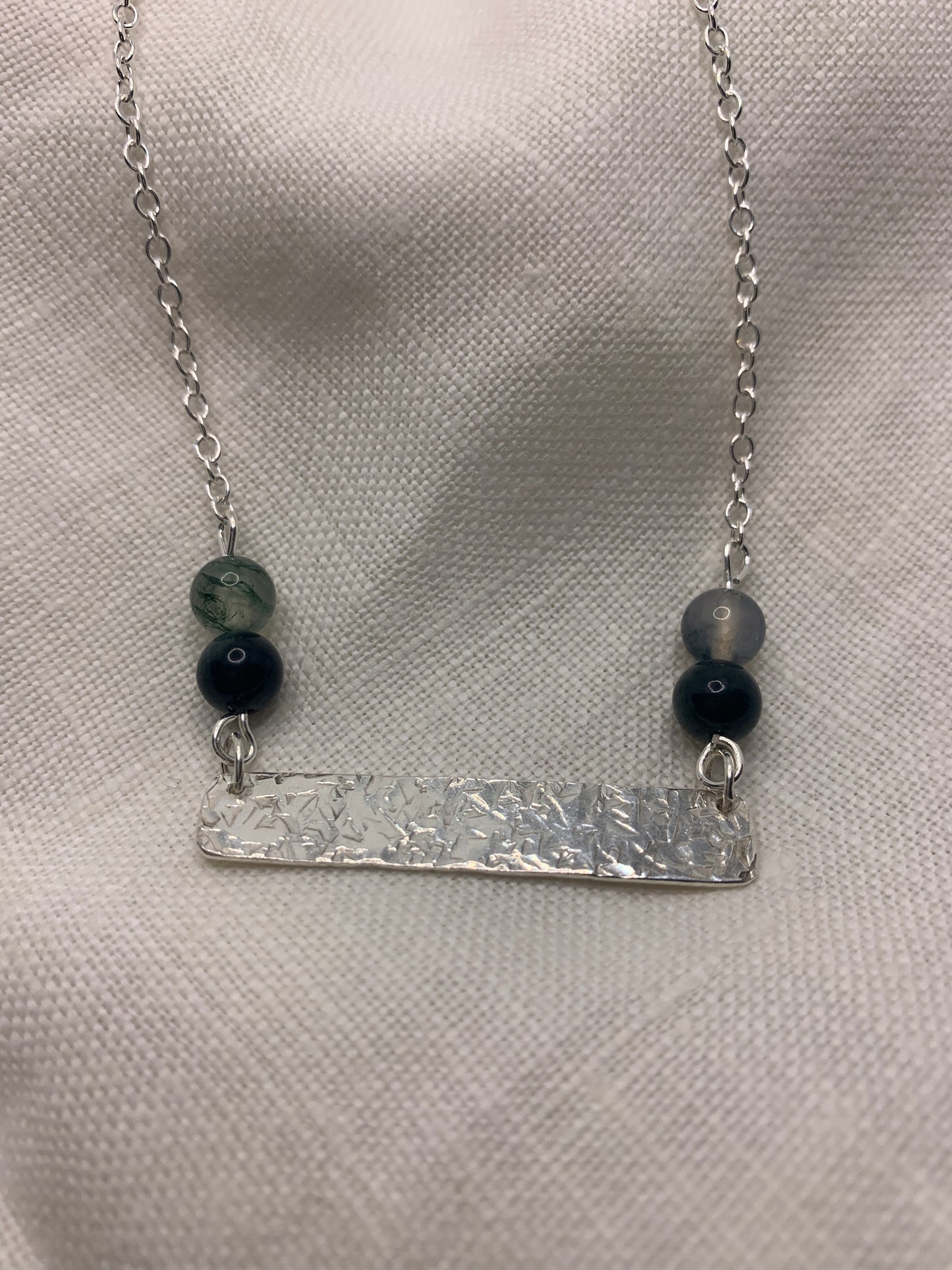 Handmade sterling silver hammered bar necklace with moss agate