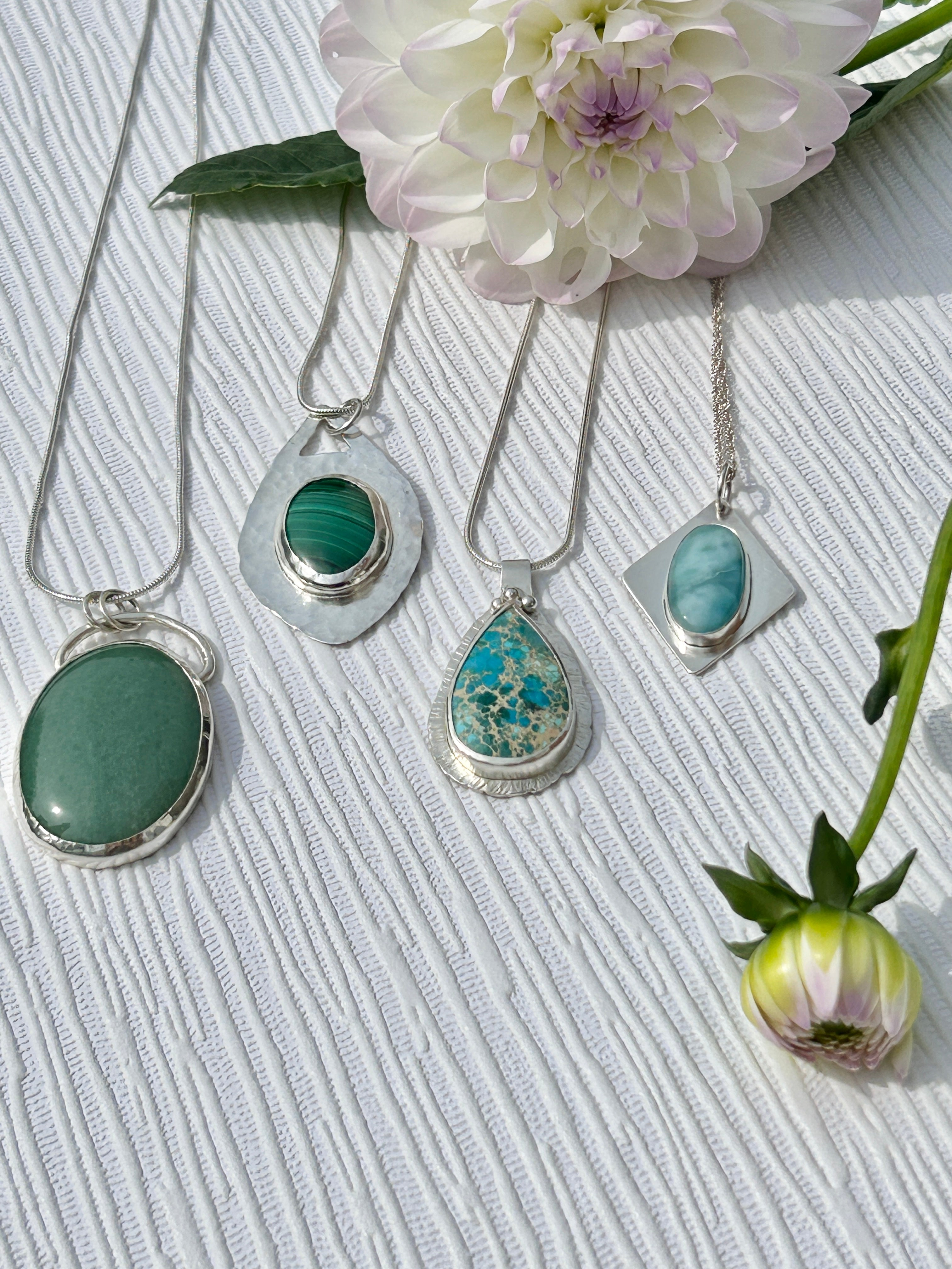 Collection of handmade sterling silver pendants with semiprecious gemstones of aventurine, malachite, sea jasper and larimar 
