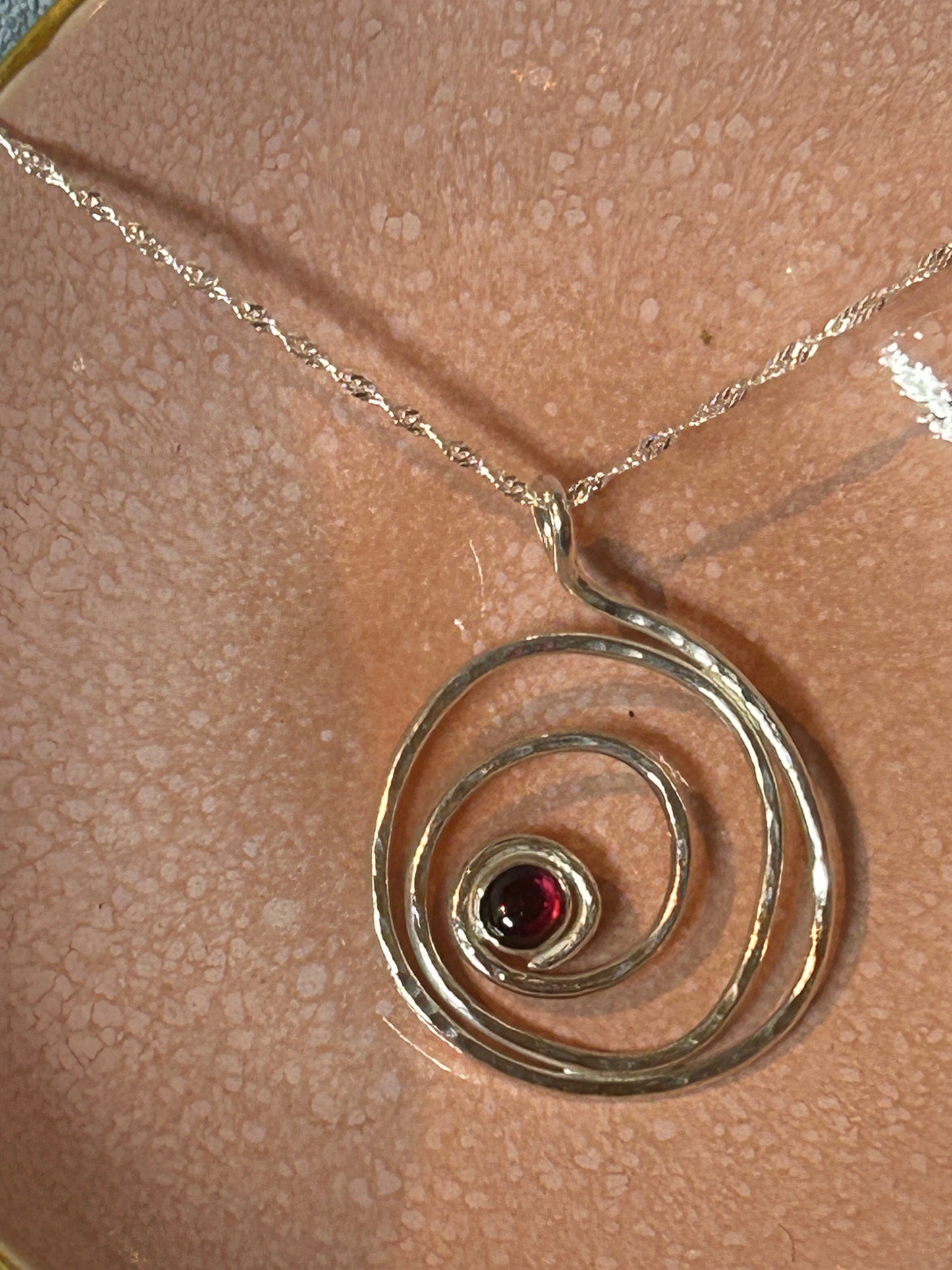 Handmade hammered garnet and sterling silver pendant 