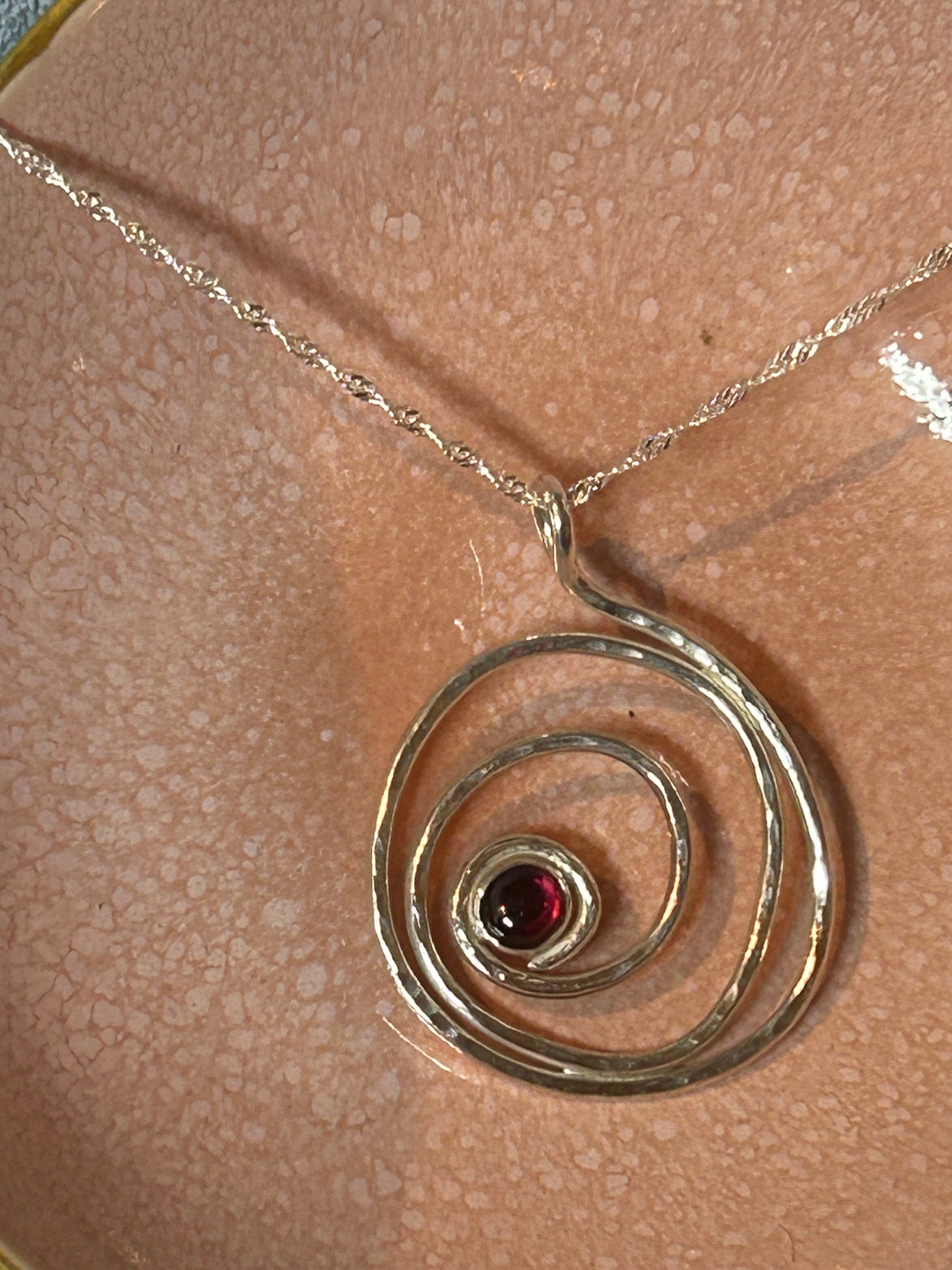 Handmade hammered garnet and sterling silver pendant 