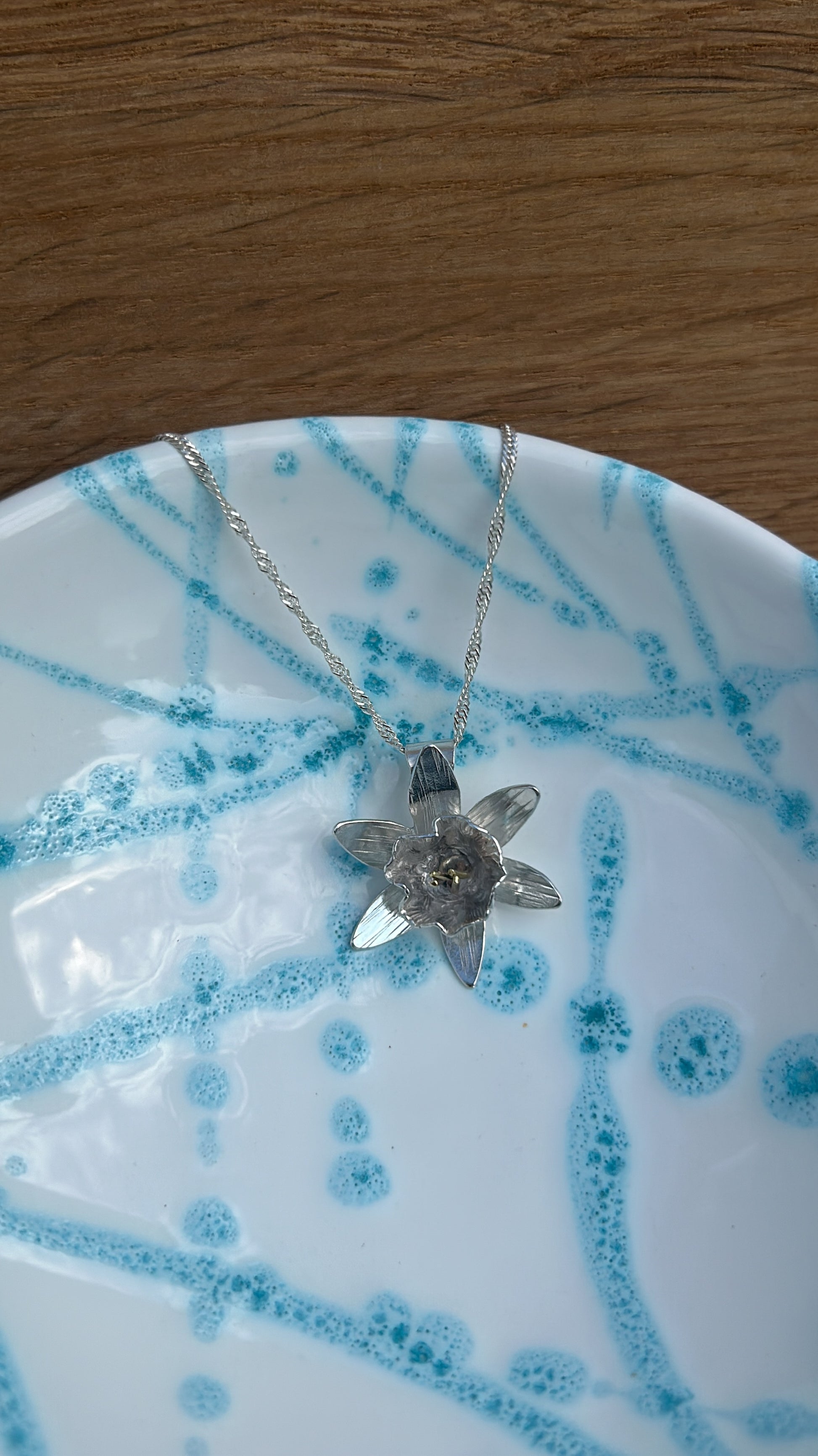 Handmade sterling silver pendant in the shape of a daffodil flower