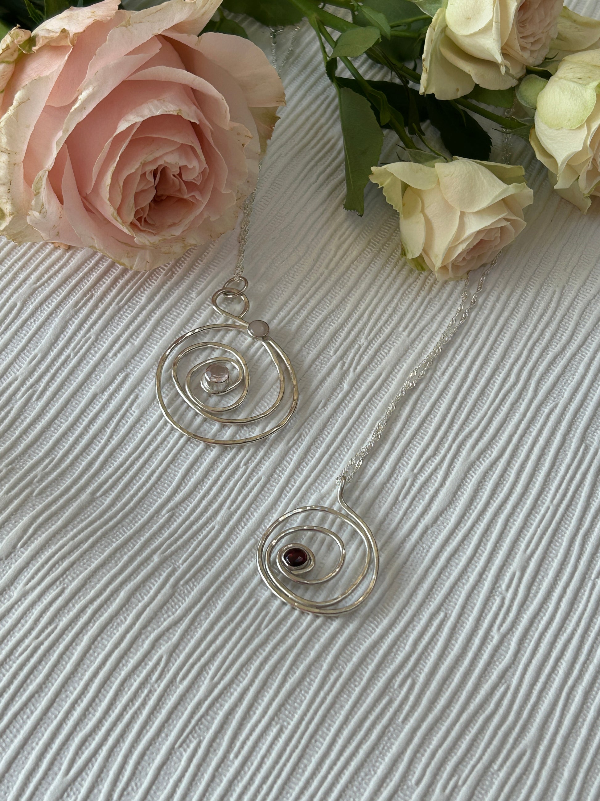 Handmade sterling silver pendants with rose quartz and garnet