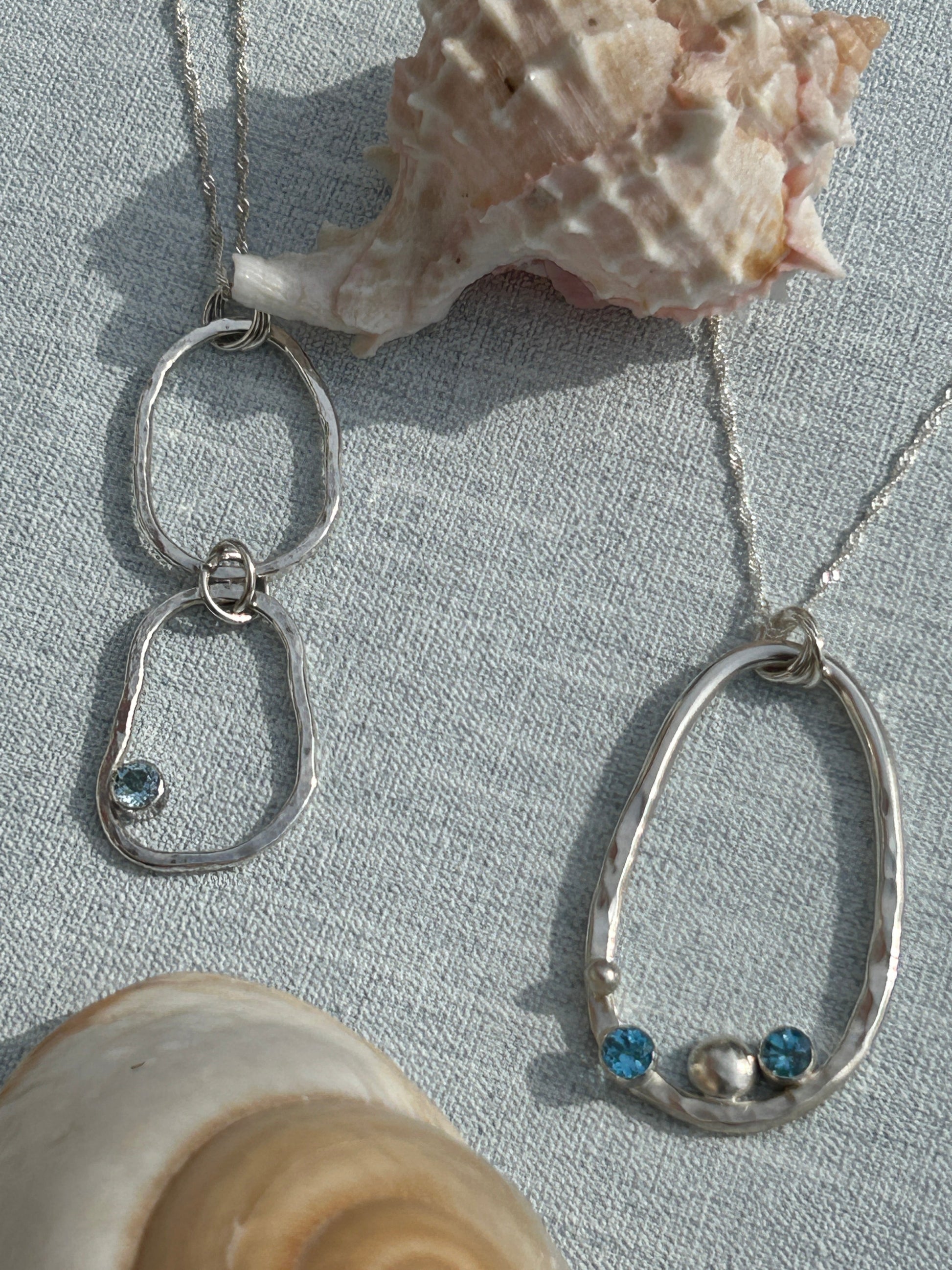 two pendants from the Provence collection. Handmade in sterling silver and blue topaz