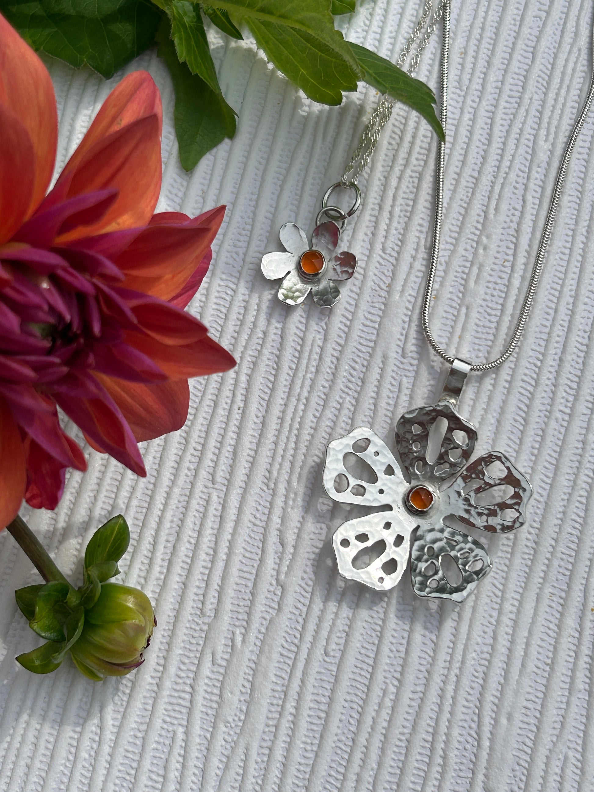 Handcrafted sterling Silver floral pendants set with orange carnelian gemstones 